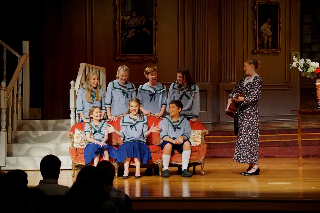 Sound of Music children singing on couch