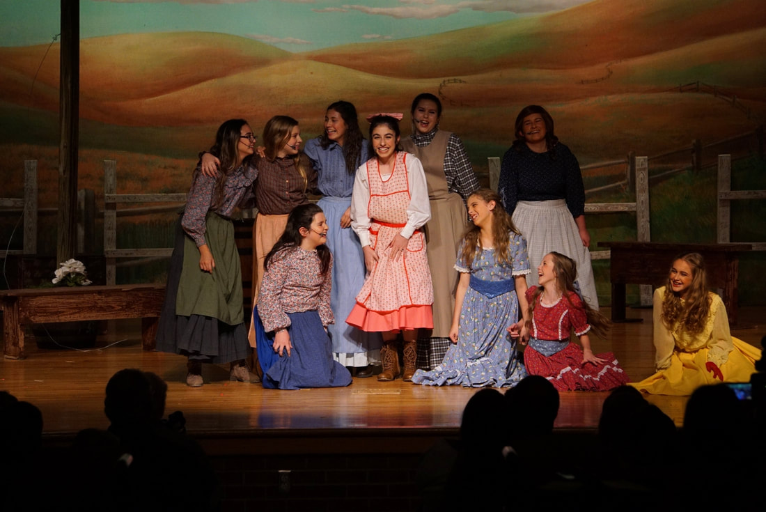 Oklahoma musical chorus girls gather around lead