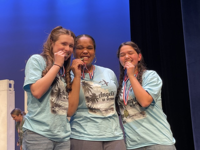 Winners biting medals from Angels of Bataan
