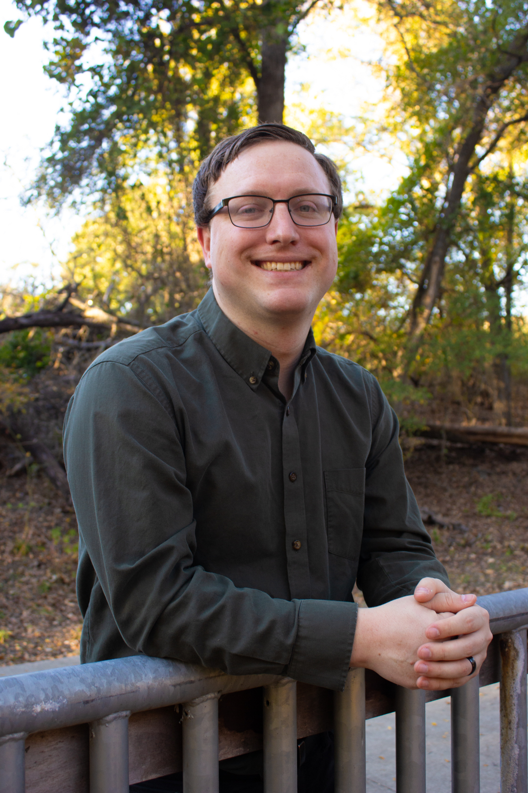A headshot of private voice teacher Michael Loeffler, smiling against an outdoor background