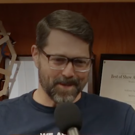 Teacher speaking into a microphone