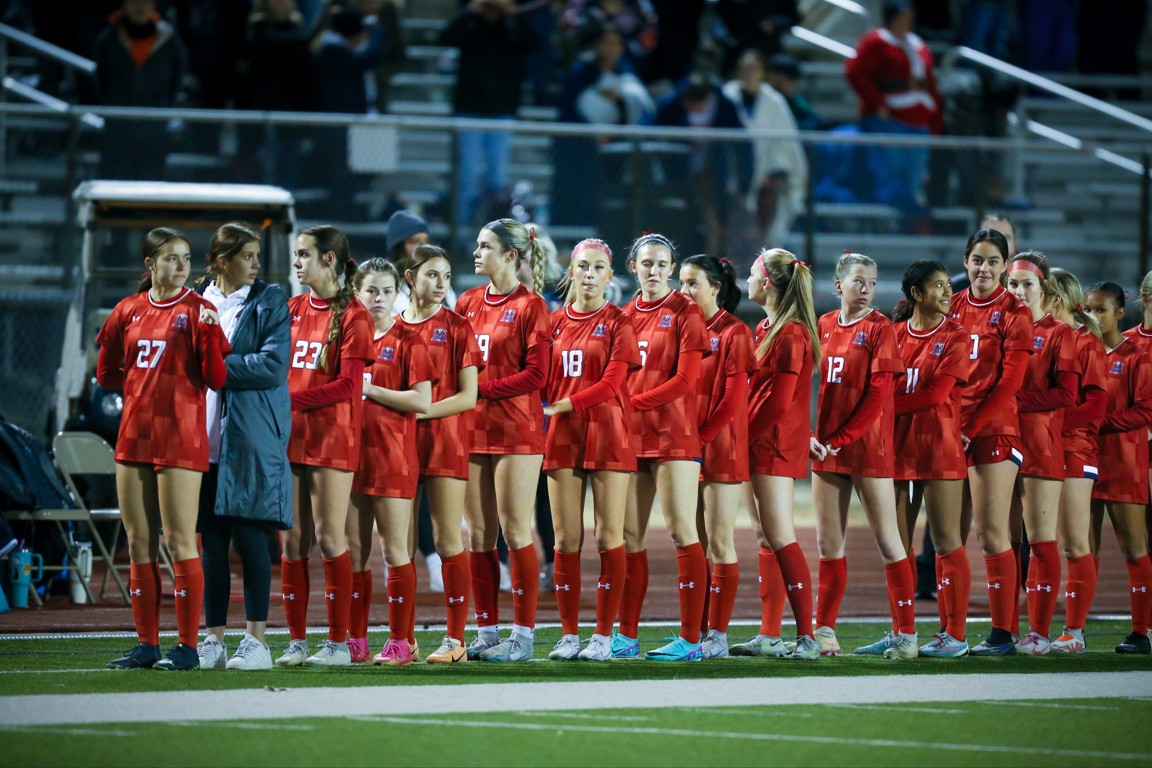 GIRLS SOCCER  TEAM LINED UP FOR NATIONAL ANTHEM IN RED UNIFORMS - HOME GAME