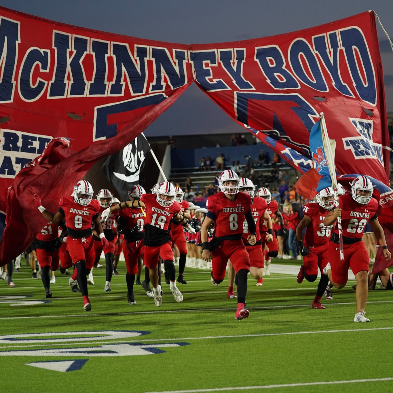 Football team running onto field