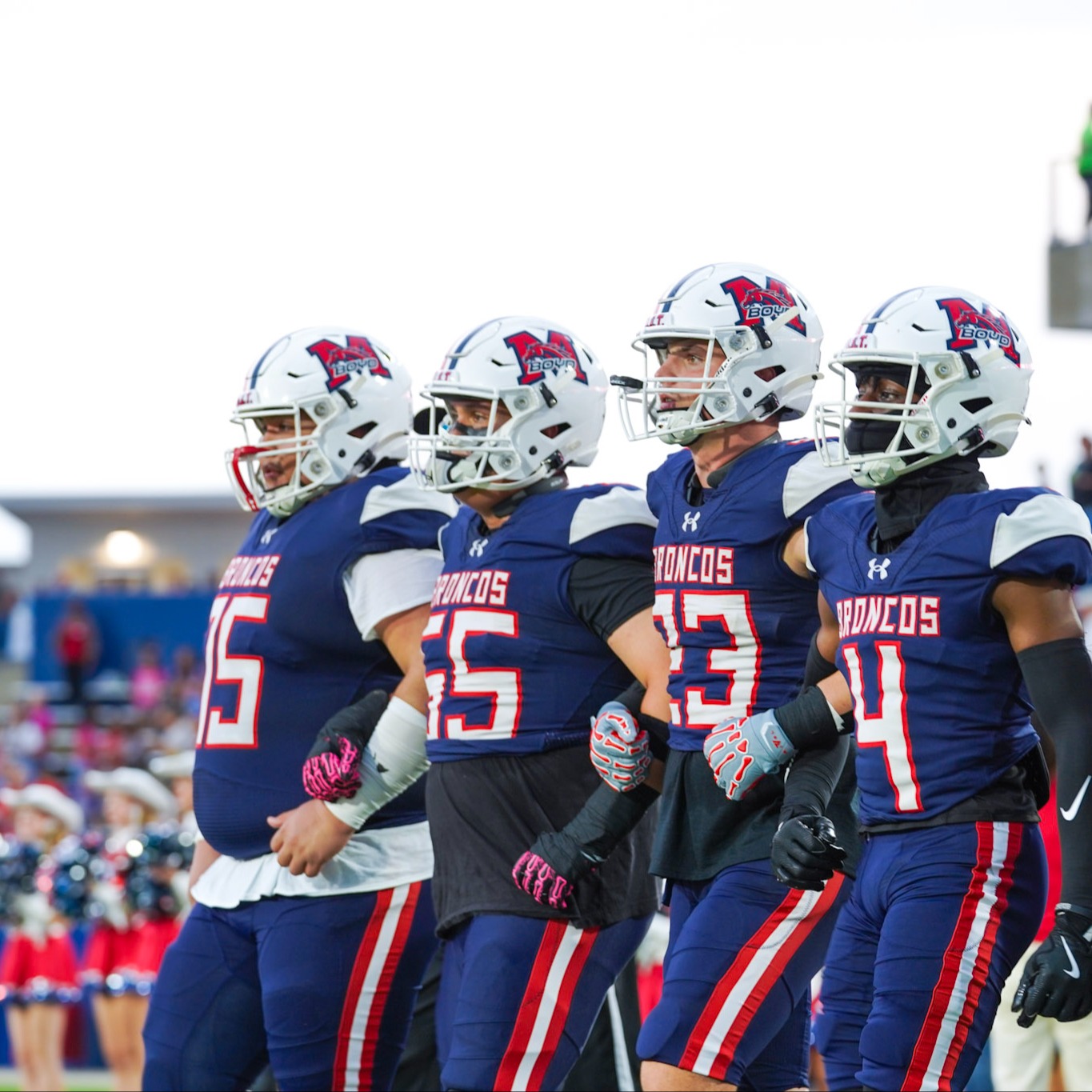 Football captains walking onto field for coin toss