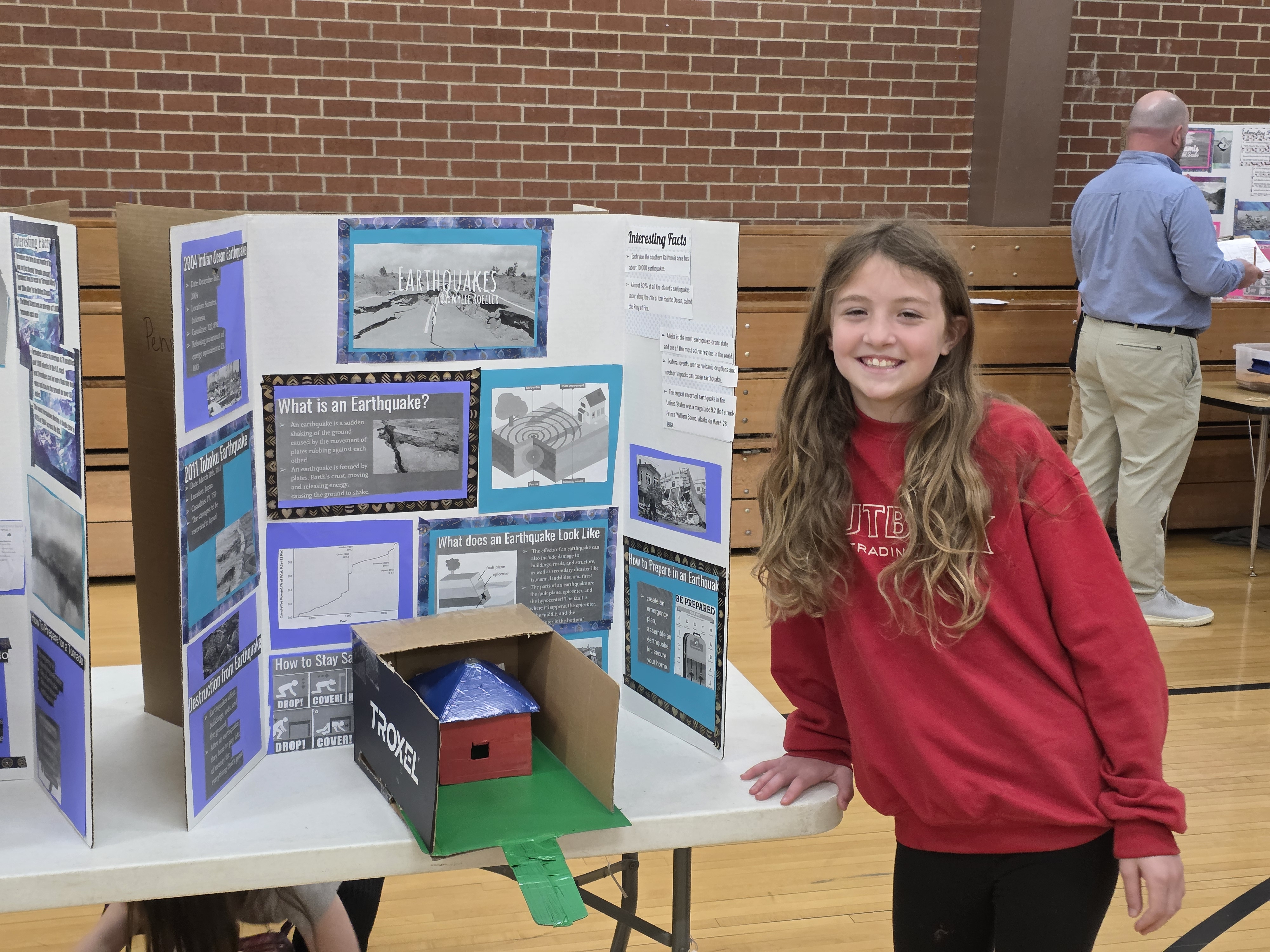 student posing with science project