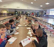 students in the classroom sitting and smiling