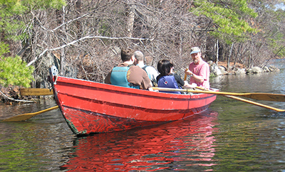 A group of people enjoying a boat ride on a calm lake.