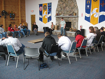 Several individuals seated in chairs, engaged in conversation.