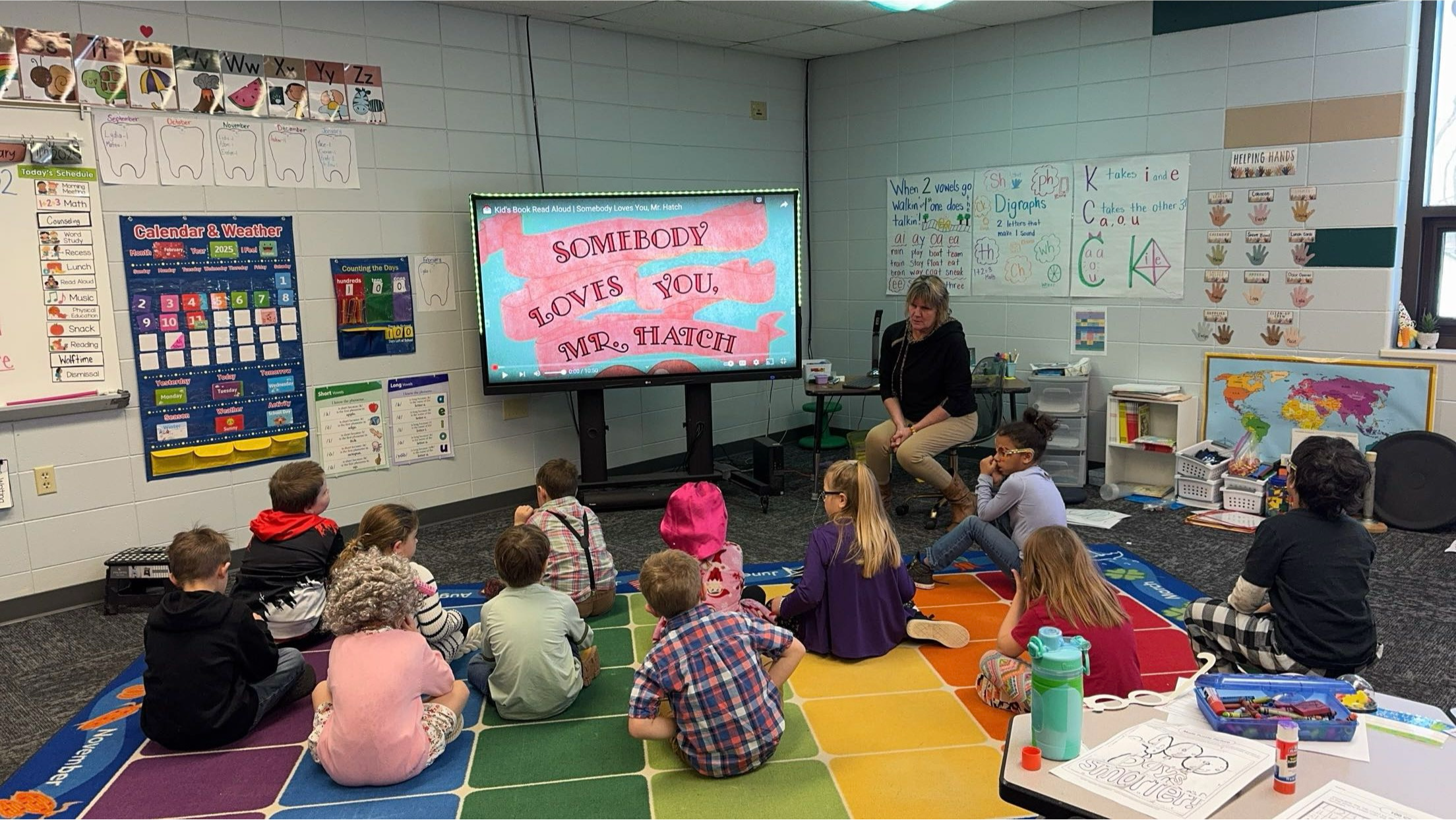 Ms. U teaching a lesson to the first grade students