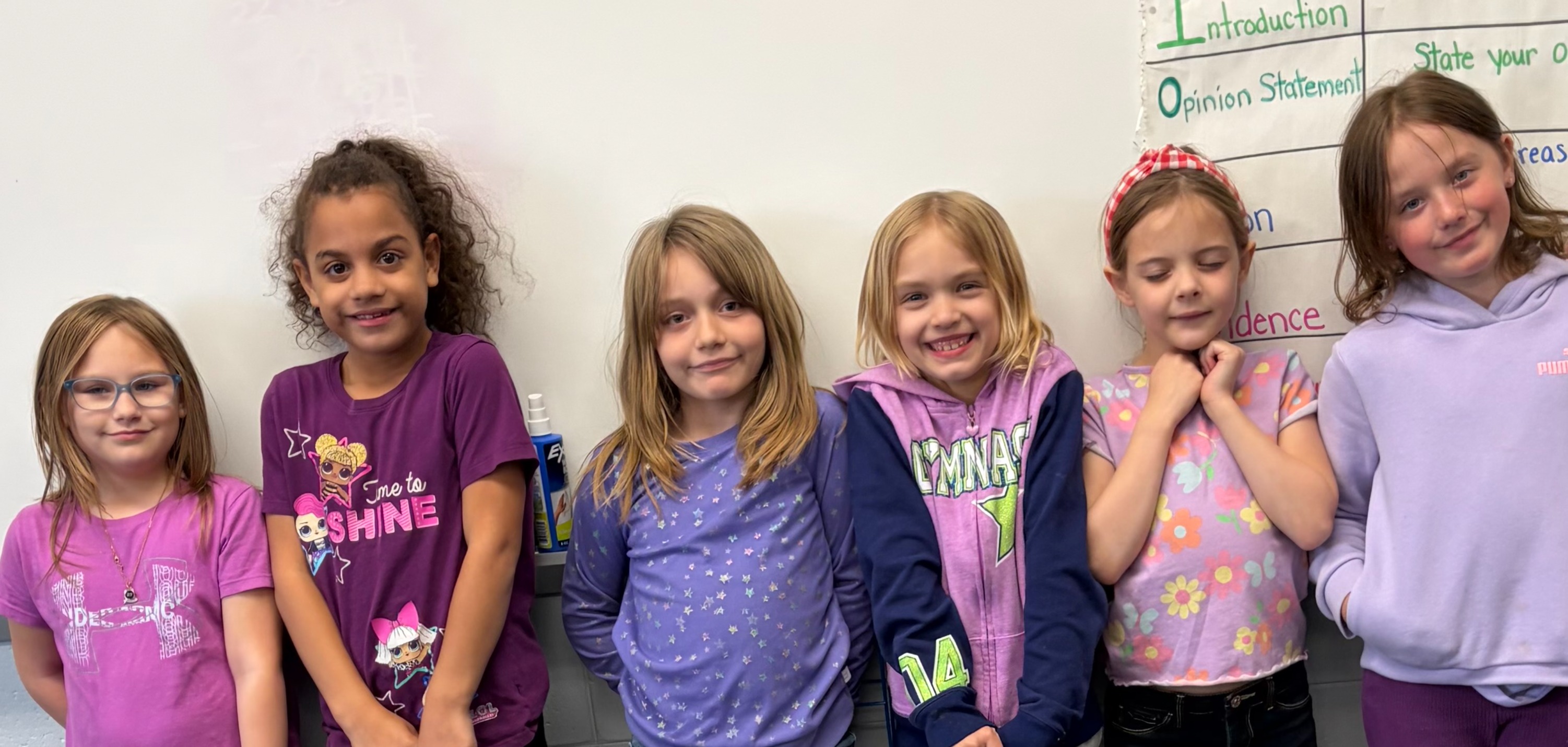 2nd grade girls wearing purple for purple day in the classroom 