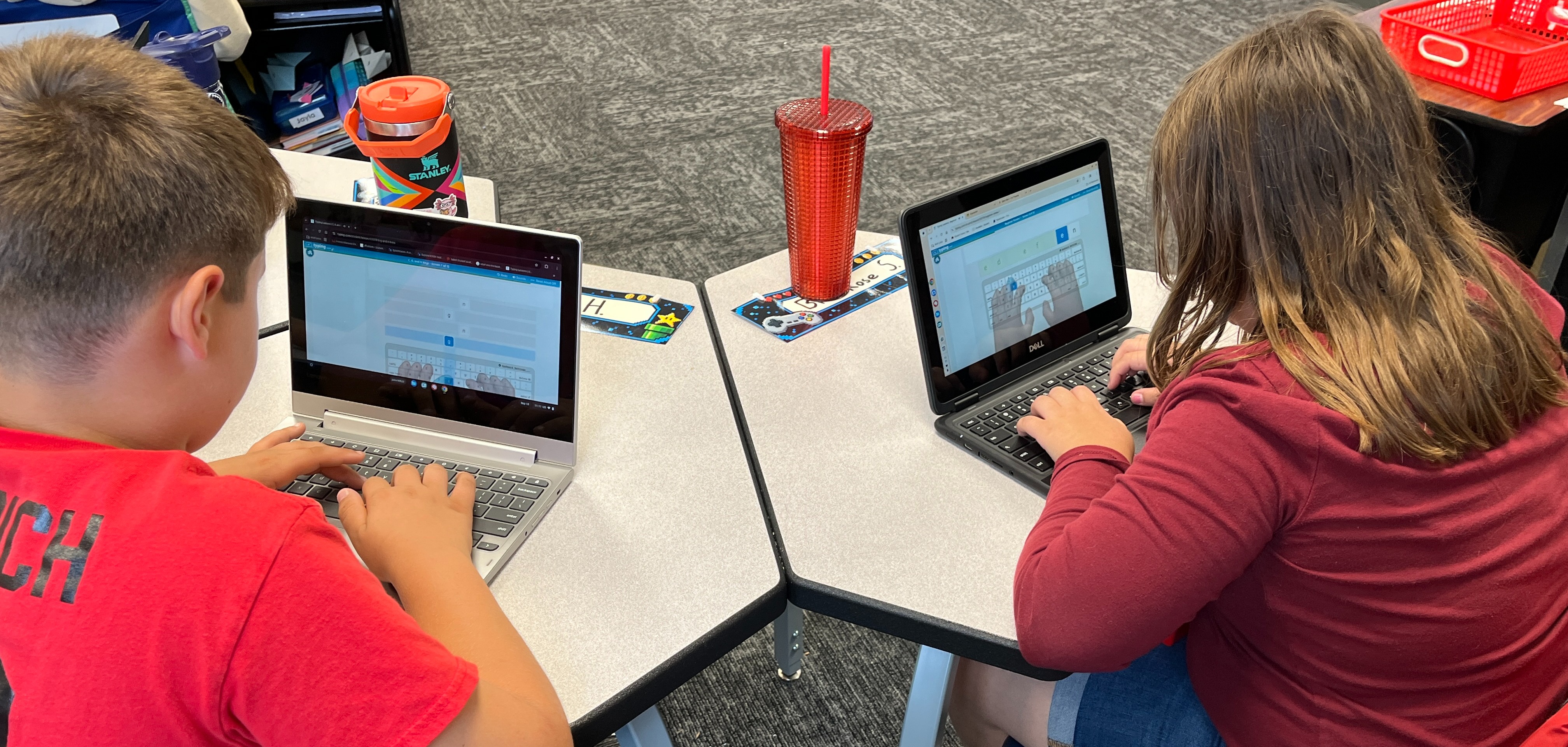 5th graders working on their keyboarding skills on the computer in the classroom 