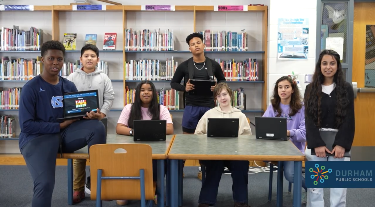 Students Holding Chromebooks
