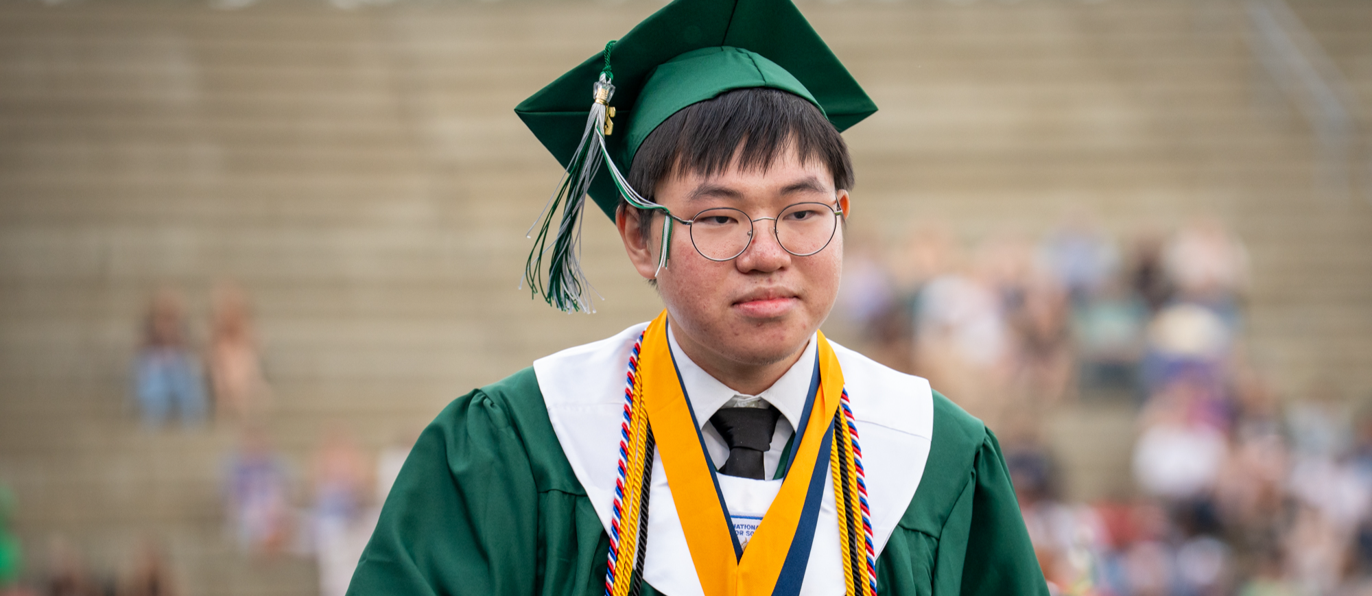 Valedictorian Jason Yang walking off stage after receiving his diploma