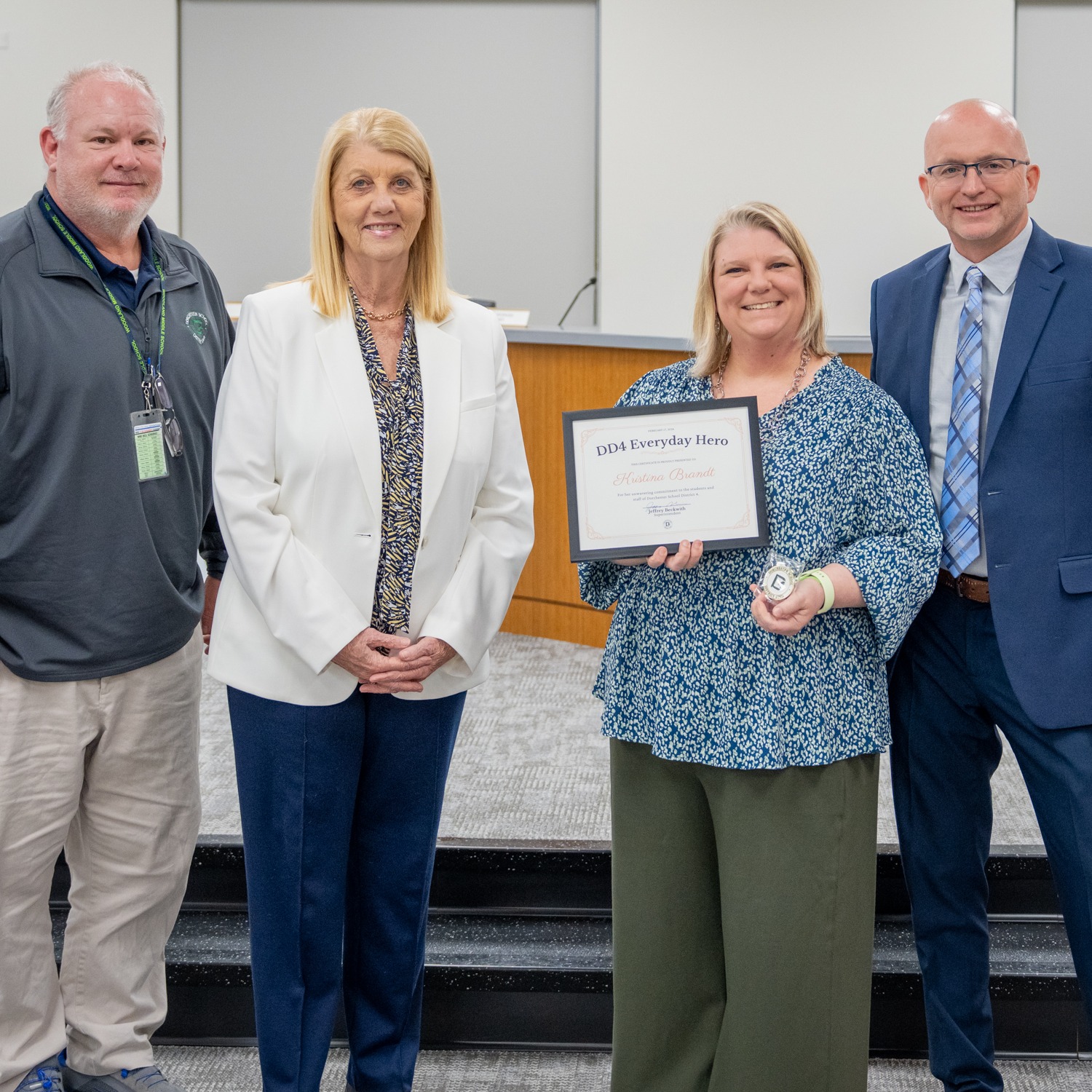 Kristina Brant accepting her award alongside Superintendent Beckwith, Board Chair Phyliss Hughes and Principal Kennedy. 