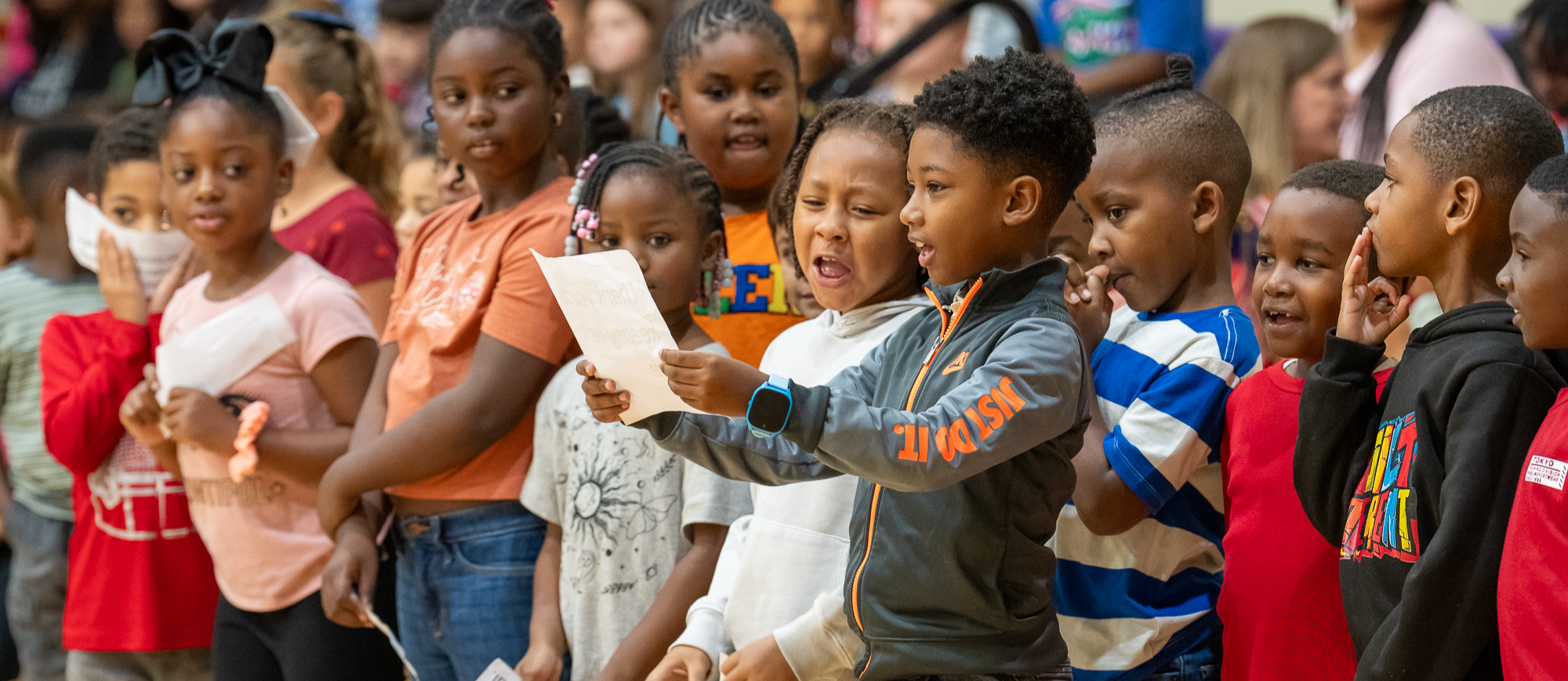 student reading poem at veteran's day program