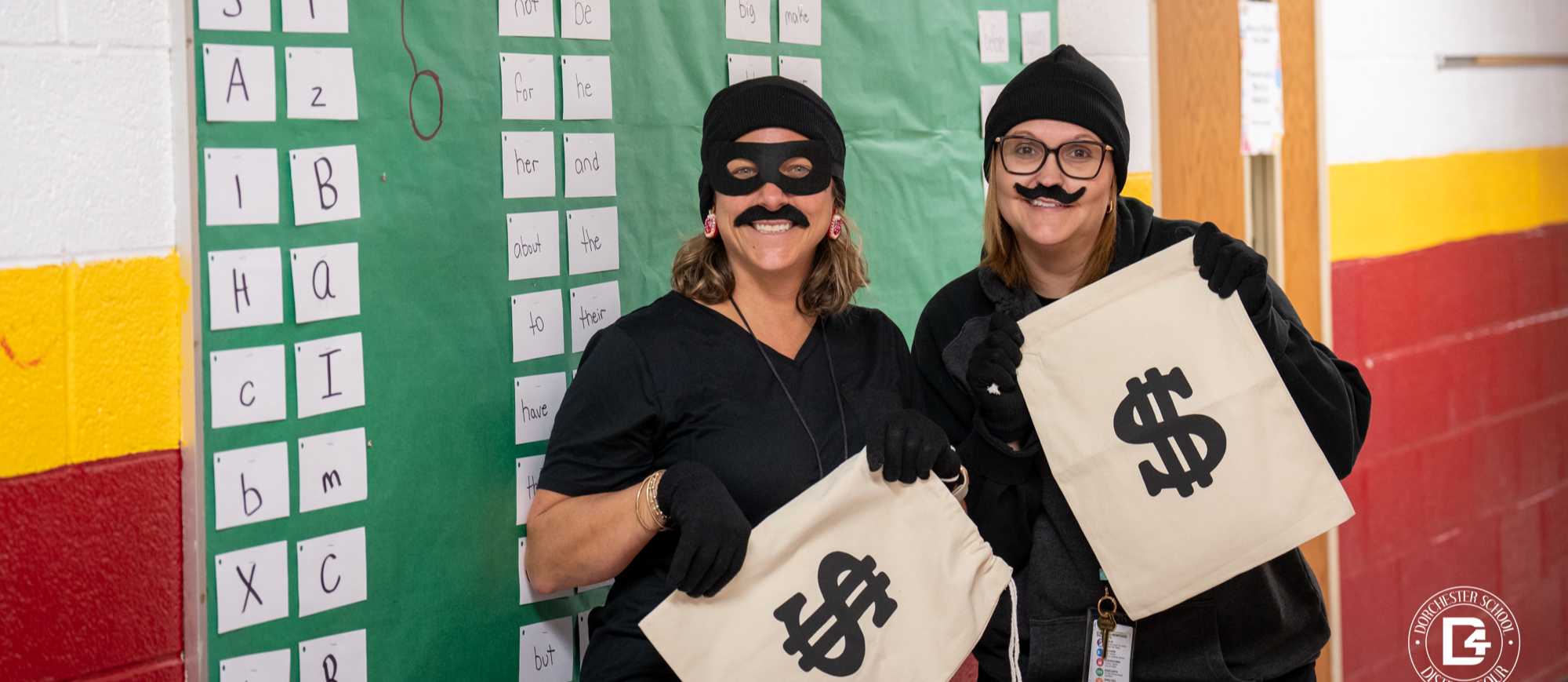 teacher dressed up with mustaches for literacy night