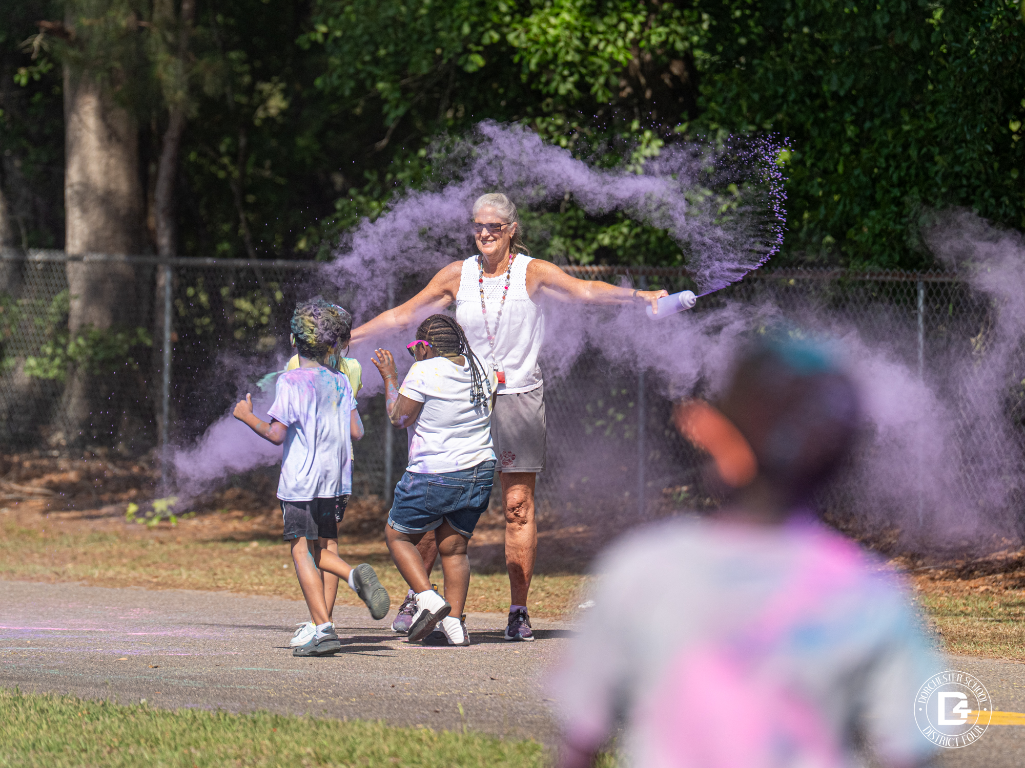 Photo of 3rd Annual Color Run with Principal putting color on students
