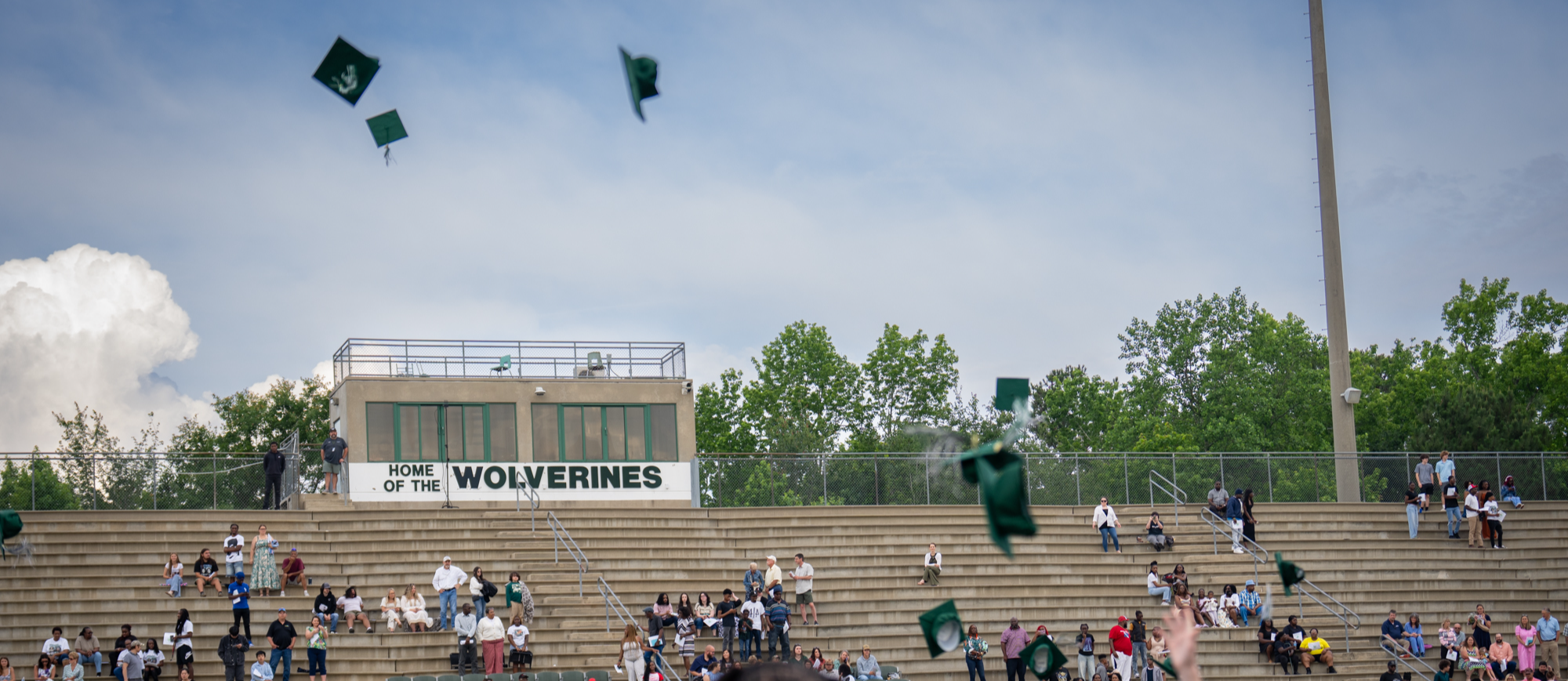 graduates throwing their caps in the air