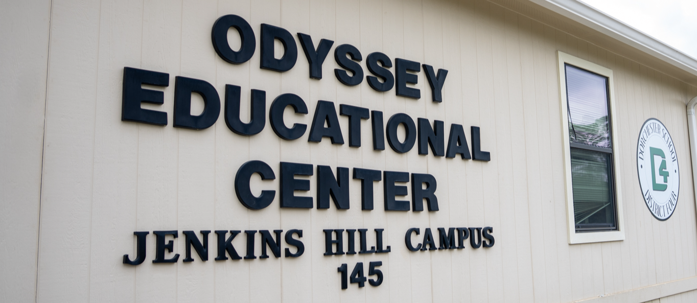 Exterior view of Odyssey Educational Center, Jenkins Hill Campus, showing the building’s sign and Dorchester School District Four logo on the side.