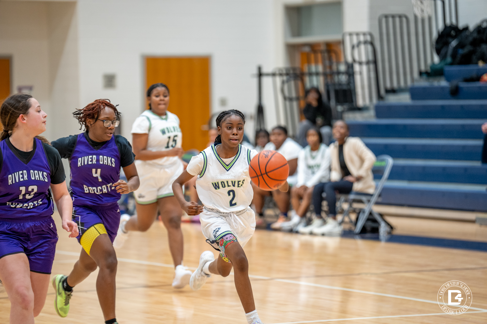 WMS Lady Wolf running up the court