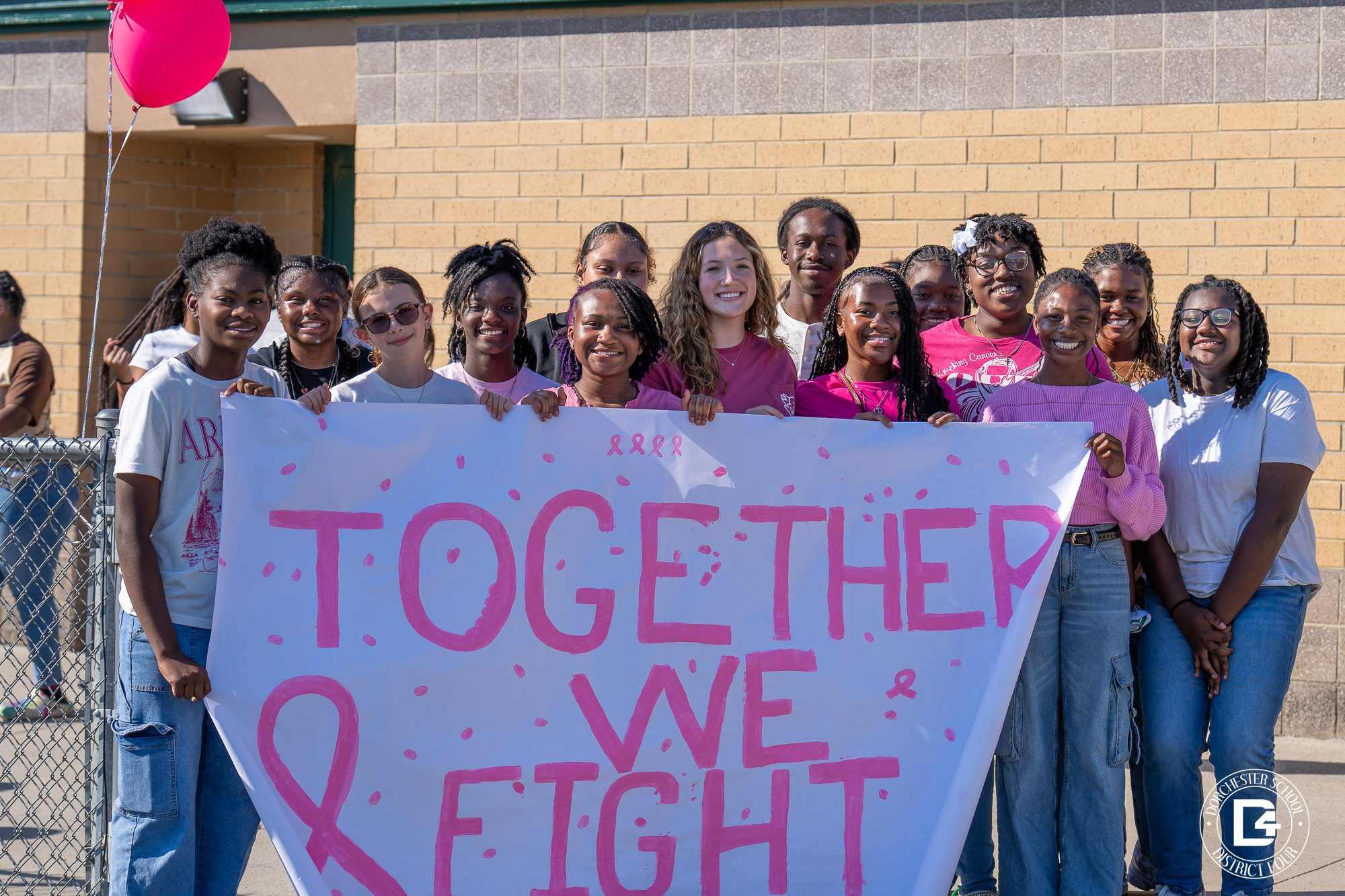 WHS Students holding together we fight sign at breast cancer awareness walk