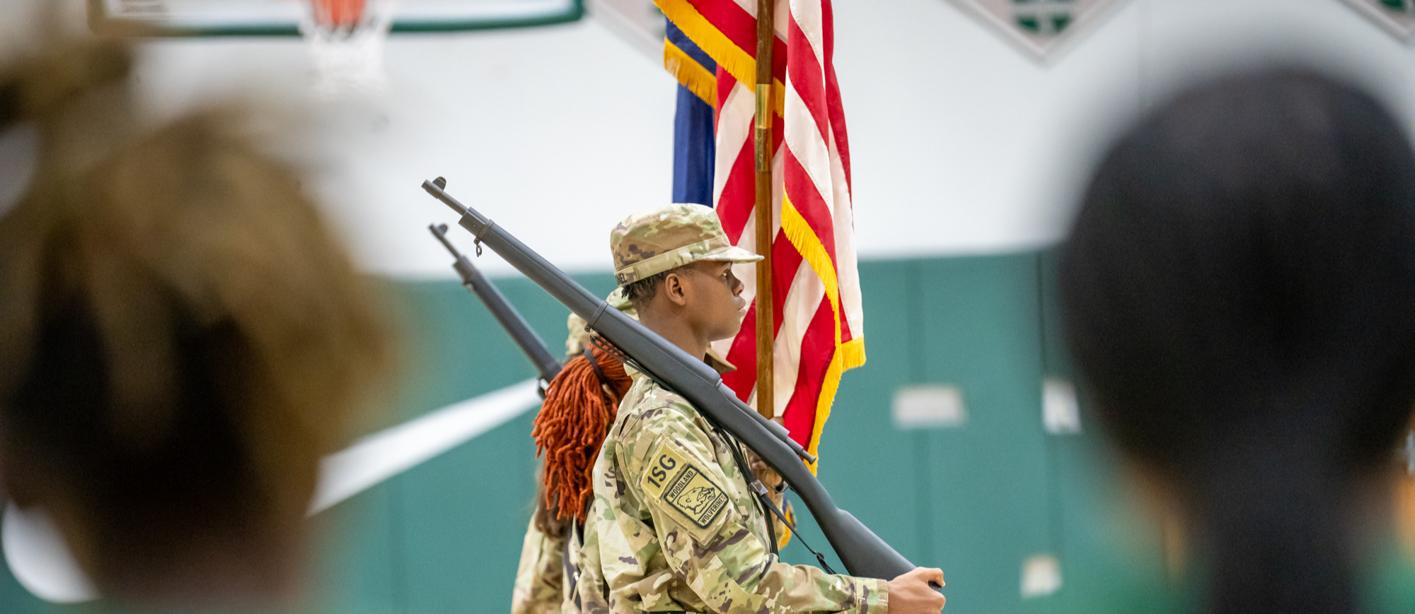 WHS Jrotc cadet marching in basketball game side profile