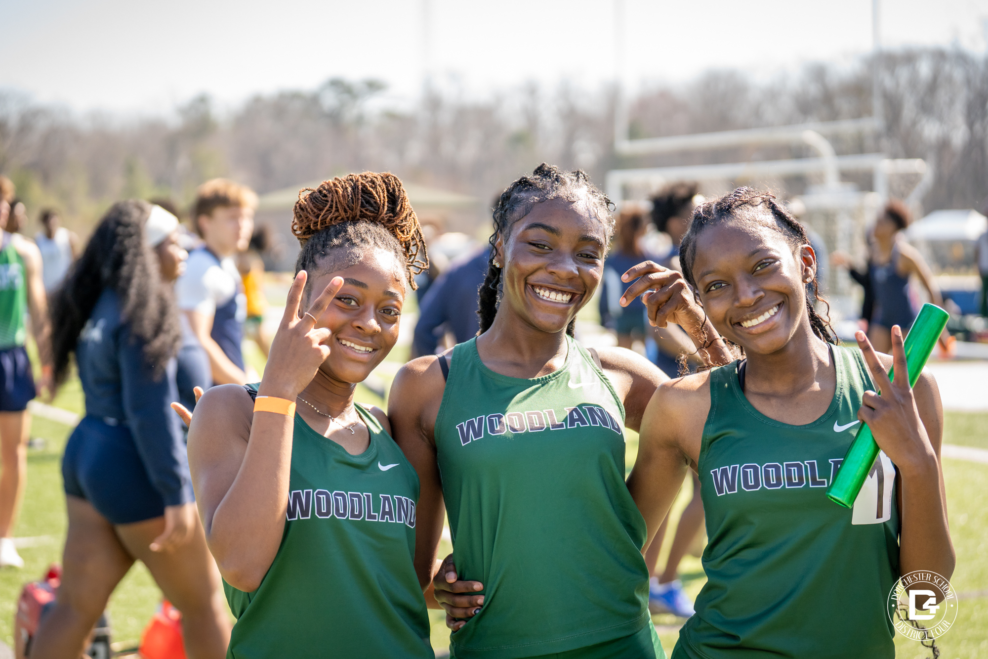 3 lady wolverines at track & Field tournament posing