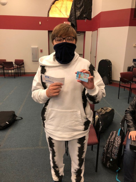 student happy at facilities wearing a mask