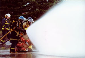 Firefighters spraying water from hoses.