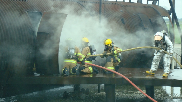 Firefighters working to extinguish a blaze in an industrial setting.