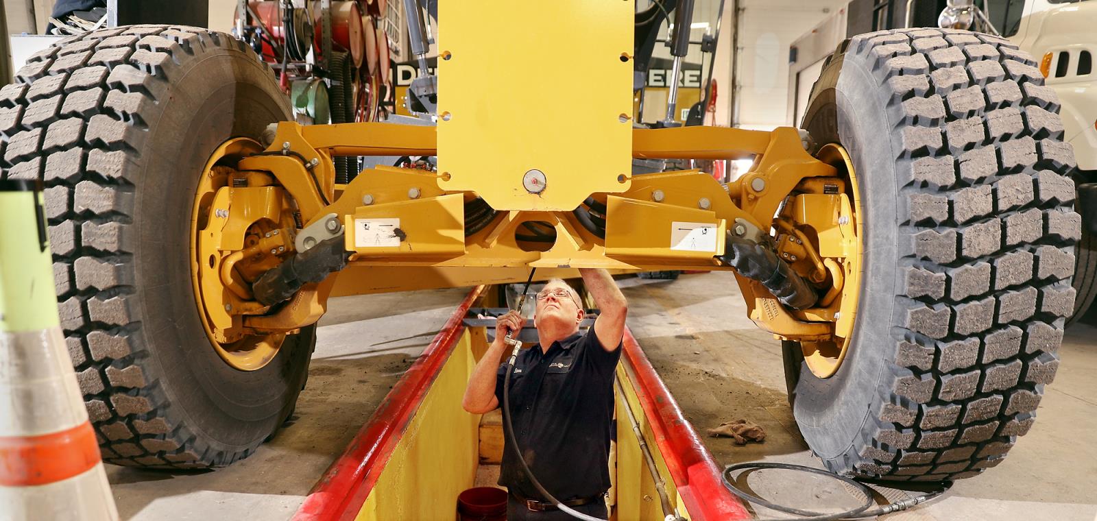 Man fixing tractor