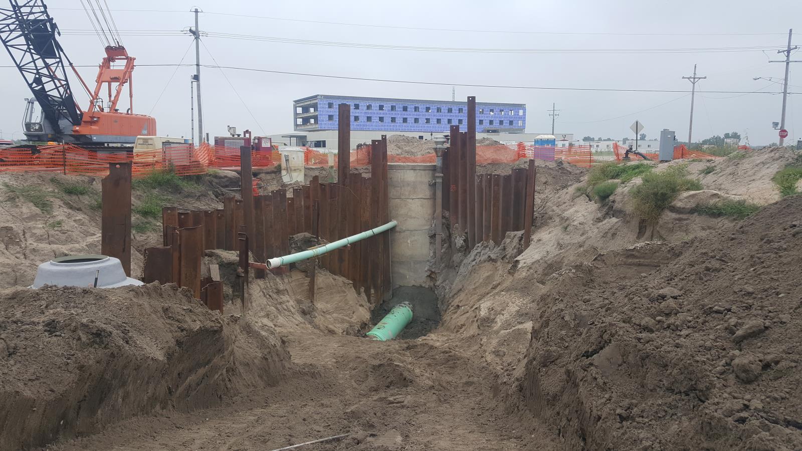 Bypass pumping is underway in order to make final connections. The new hospital can be seen in the background. 2018-08-24