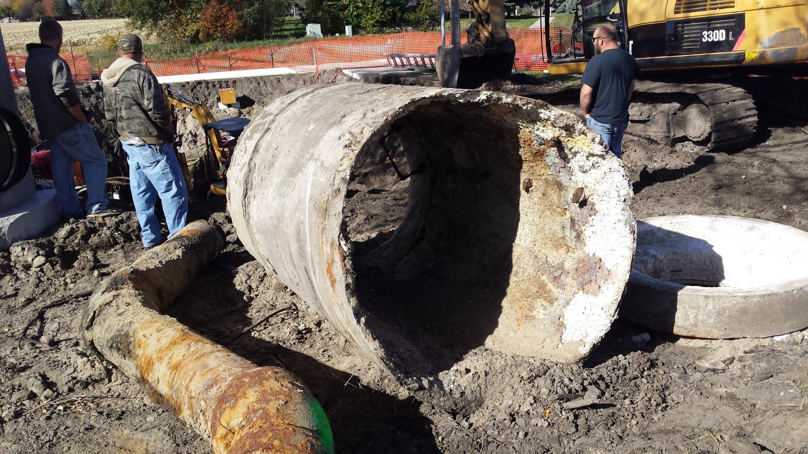 Workers repairing drainage system