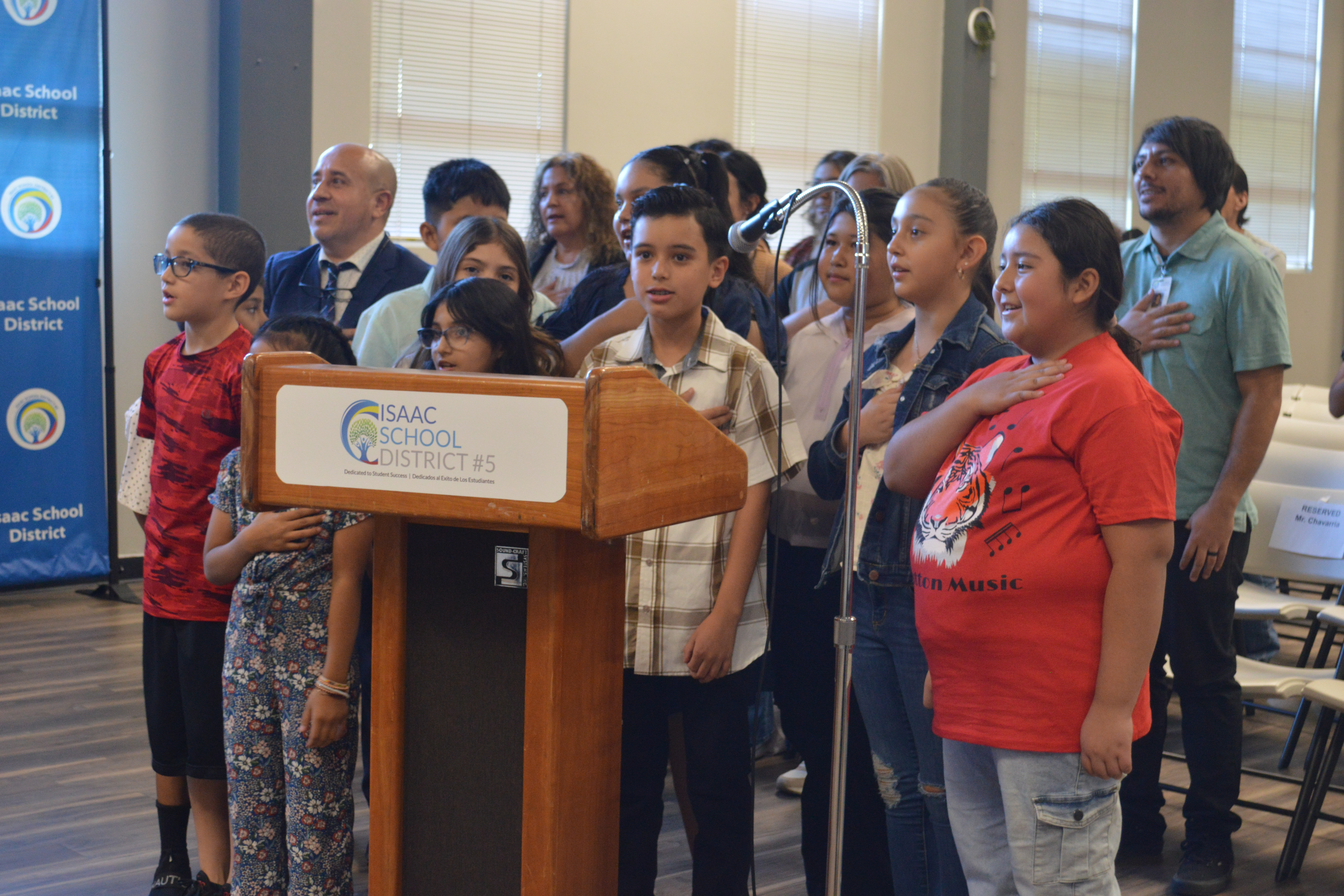 ISD administrators reciting pledge with students