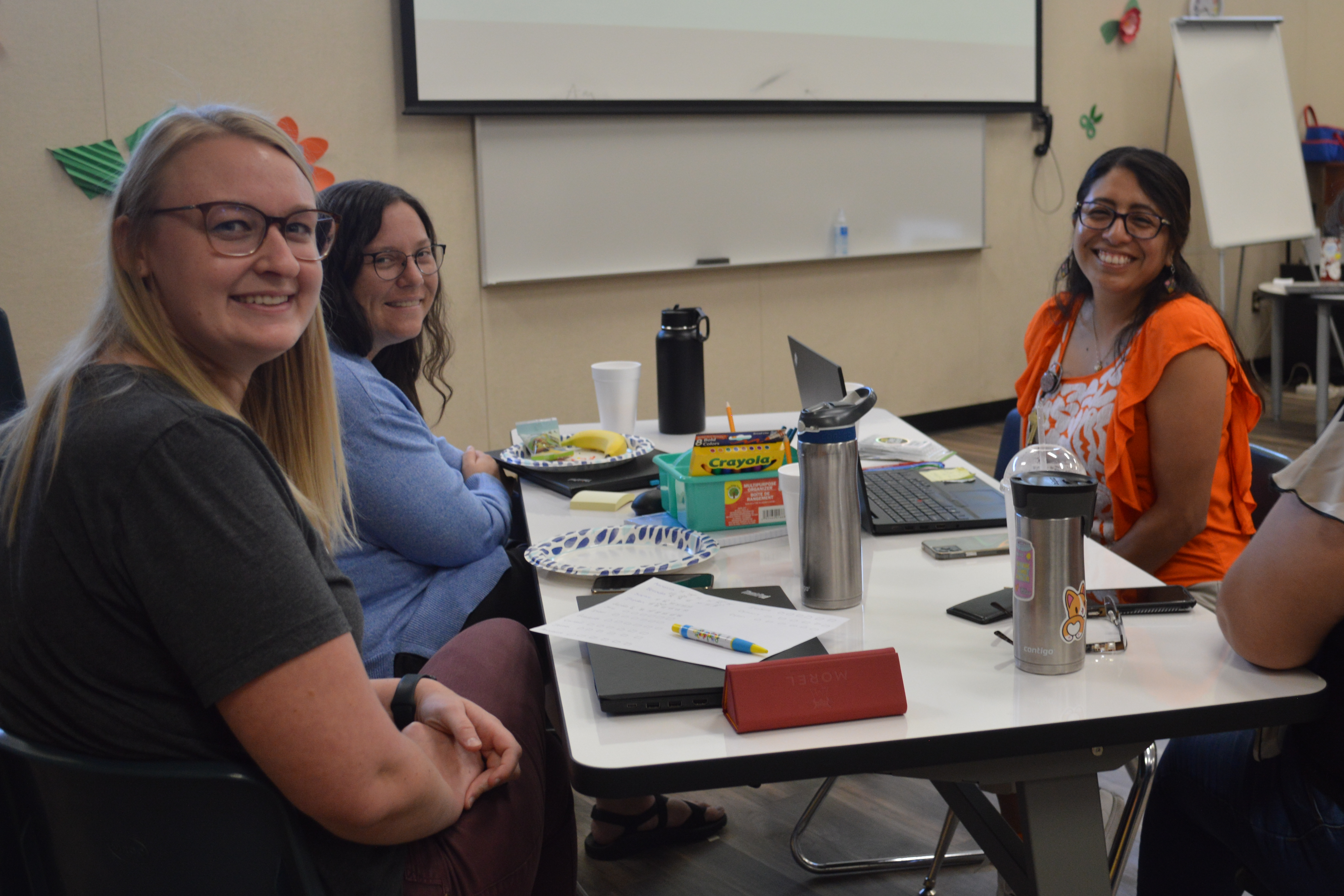 four teachers collaborating at table