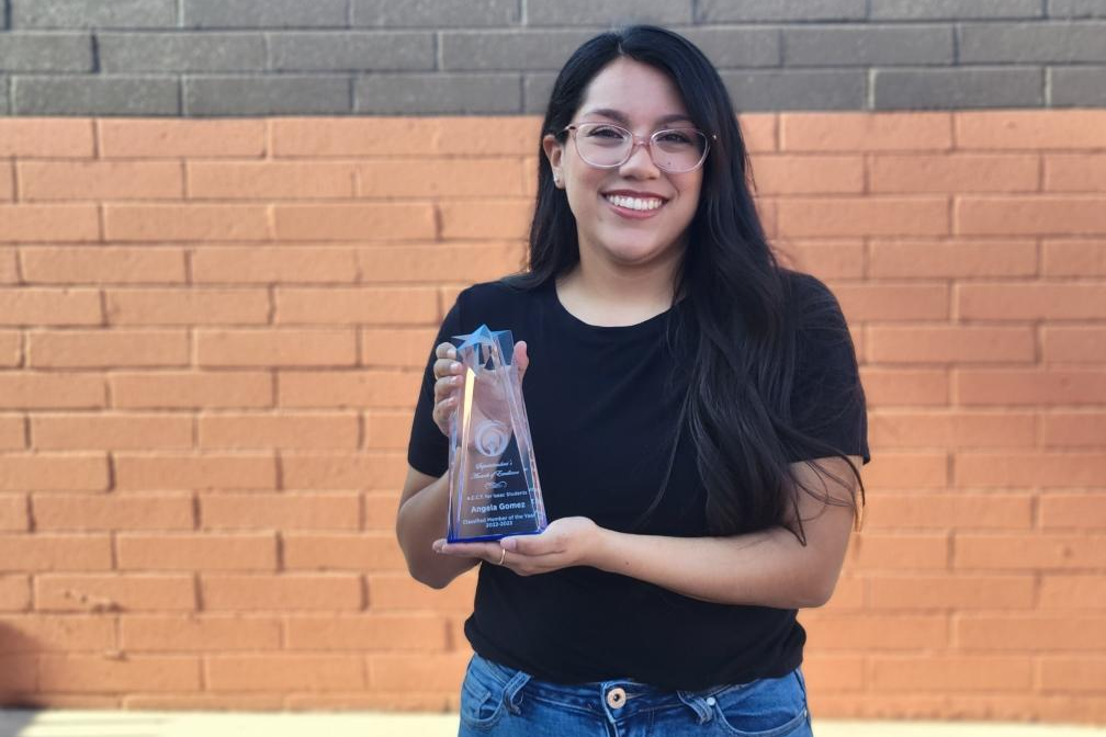 isaac staff holding award