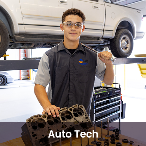 Student smiling while working with car machine