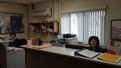 Two women sitting at a desk in an office