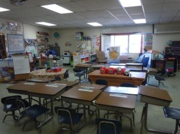 A classroom filled with lots of desks and chairs