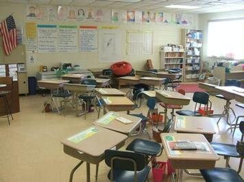 A classroom filled with lots of desks and chairs
