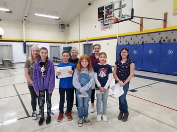 A group of children holding up their awards