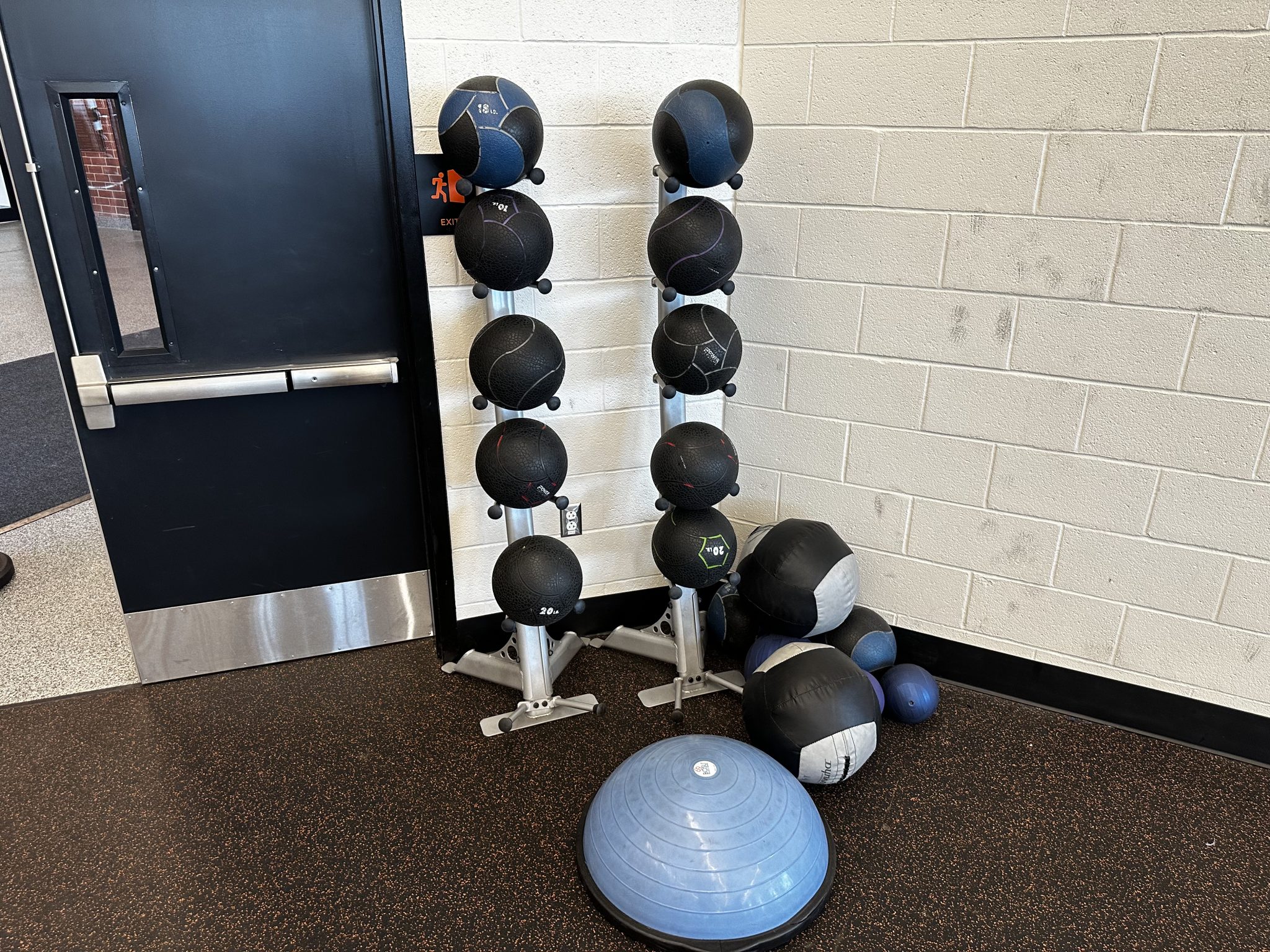 A vibrant gym filled with colorful exercise balls and various weights, inviting fitness enthusiasts to work out and stay active.
