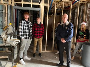  Four firefighters stand together in a new fire station under construction