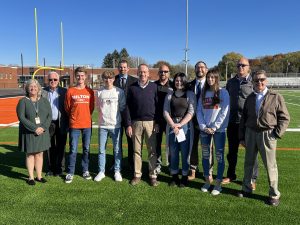  A group of people stands together on a football field