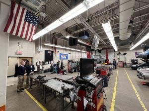 A spacious room featuring a large American flag hanging prominently from the ceiling