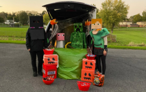 Two people in a van, dressed as Minecraft characters