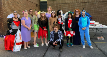 A lively group of people in colorful Halloween costumes