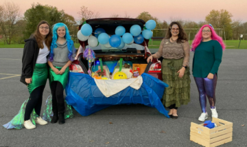 Four women in colorful mermaid costumes