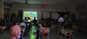 A busy classroom filled with students sitting at desks