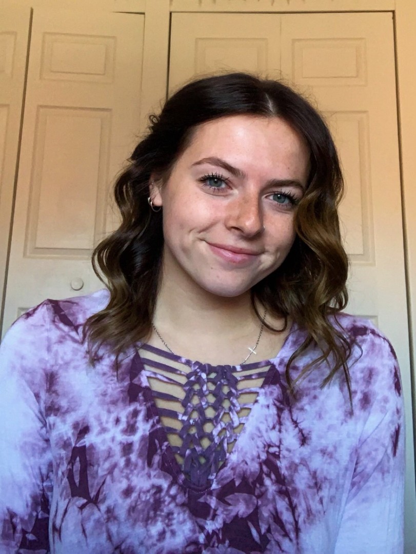 A woman in a purple tie dye shirt.